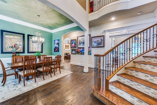 2458 W Creek Dr, Frisco, TX 75033 - dining space with arched walkways, stairway, wood finished floors, a chandelier, and crown molding