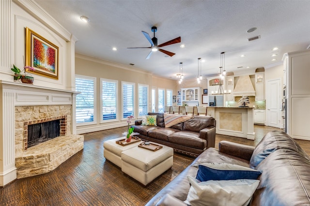 2458 W Creek Dr, Frisco, TX 75033 - living room with ceiling fan, crown molding, wood finished floors, a stone fireplace, and recessed lighting