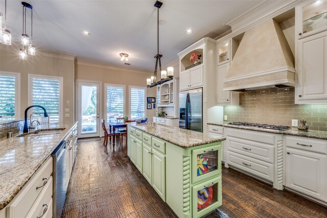 2458 W Creek Dr, Frisco, TX 75033 - kitchen with appliances with stainless steel finishes, custom range hood, a sink, white cabinets, and crown molding