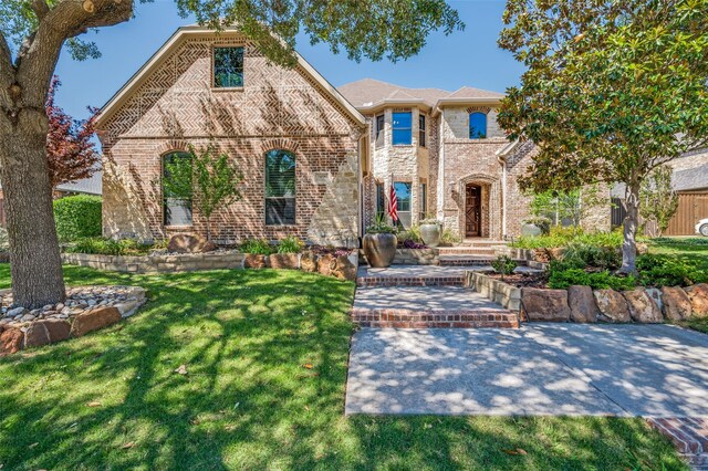 2458 W Creek Dr, Frisco, TX 75033 - french country inspired facade with brick siding and a front yard