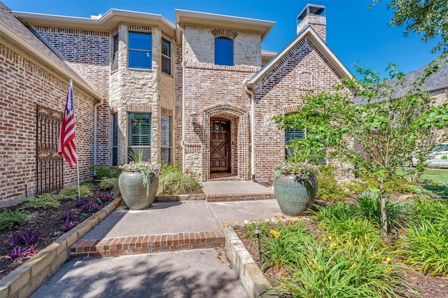 2458 W Creek Dr, Frisco, TX 75033 - doorway to property with brick siding and a chimney