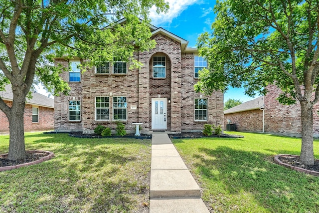 1722 Harvest Crossing Dr, Wylie, TX 75098 - traditional-style home with a front lawn, brick siding, and central AC unit