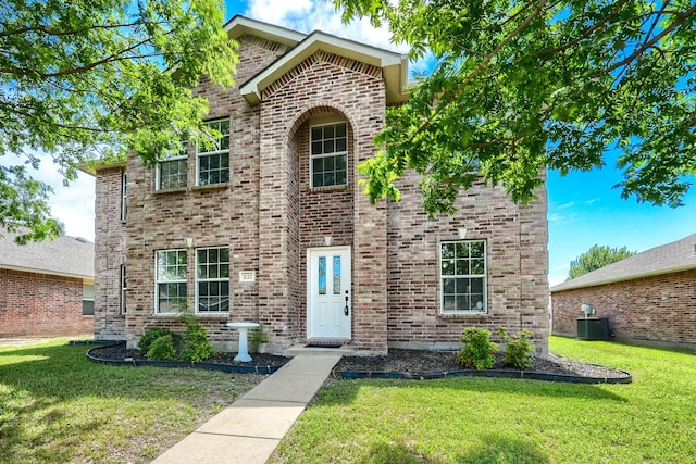 1722 Harvest Crossing Dr, Wylie, TX 75098 - traditional home with cooling unit, a front yard, and brick siding