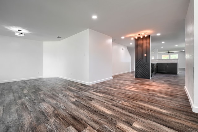 1722 Harvest Crossing Dr, Wylie, TX 75098 - unfurnished living room featuring dark wood-style floors, baseboards, recessed lighting, and rail lighting