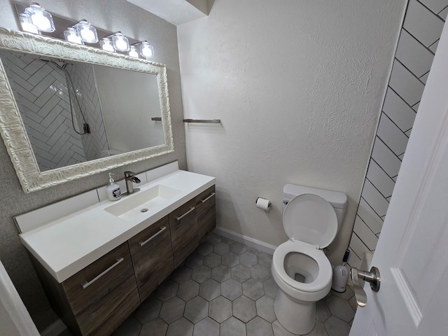 220 Bluebird Cir, Denton, TX 76209 - bathroom with toilet, vanity, tile patterned flooring, a textured wall, and baseboards
