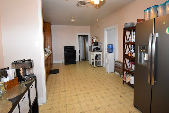 1509 S Wall, Brady, TX 76825 - kitchen featuring appliances with stainless steel finishes, light flooring, and ceiling fan