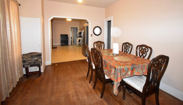 1509 S Wall, Brady, TX 76825 - dining space featuring wood finished floors, arched walkways, and baseboards