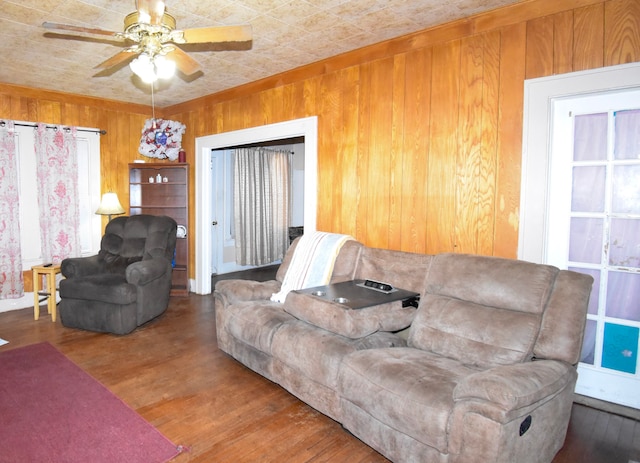1509 S Wall, Brady, TX 76825 - living area with wooden walls, wood finished floors, and a ceiling fan