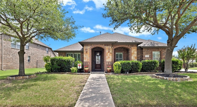 7100 King Ranch Rd, North Richland Hills, TX 76182 - view of front of property featuring brick siding, a front yard, and roof with shingles