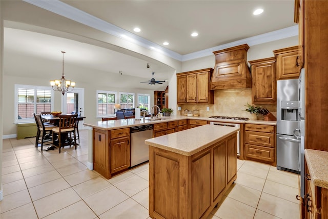 7100 King Ranch Rd, North Richland Hills, TX 76182 - kitchen with stainless steel appliances, brown cabinetry, premium range hood, a peninsula, and a sink