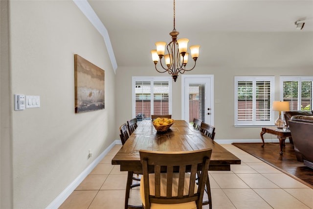 7100 King Ranch Rd, North Richland Hills, TX 76182 - dining area featuring lofted ceiling, a chandelier, light tile patterned flooring, and baseboards