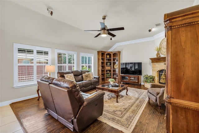 7100 King Ranch Rd, North Richland Hills, TX 76182 - living room with a ceiling fan, lofted ceiling, ornamental molding, a stone fireplace, and baseboards