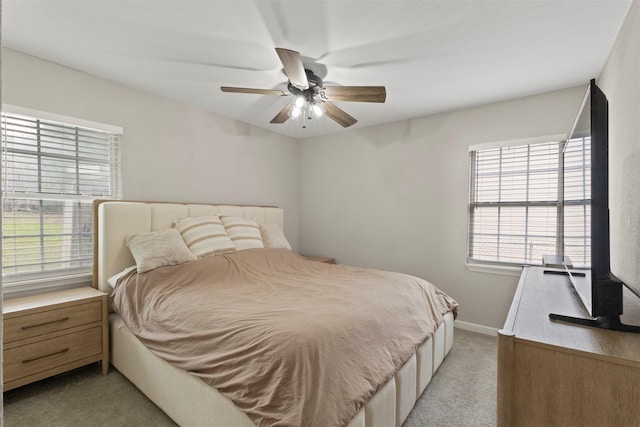 1503 Dale Dr, Arlington, TX 76010 - bedroom with light carpet, multiple windows, baseboards, and a ceiling fan