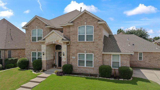 103 Daisey Ln, Justin, TX 76247 - traditional-style house with a shingled roof, a front yard, and brick siding