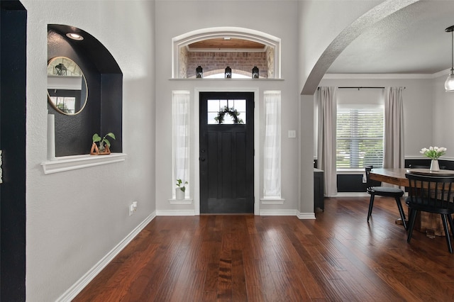 103 Daisey Ln, Justin, TX 76247 - foyer entrance with wood finished floors, baseboards, and arched walkways