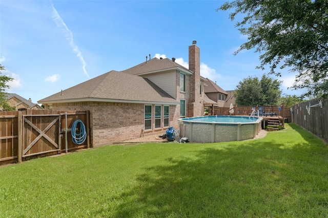 103 Daisey Ln, Justin, TX 76247 - rear view of property with brick siding, roof with shingles, and a chimney