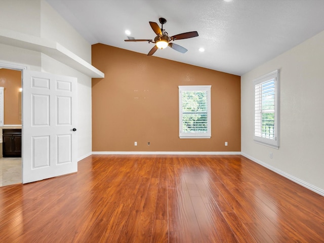 710 Crows Pt, Lake Bridgeport, TX 76426 - empty room with vaulted ceiling, wood finished floors, ceiling fan, and baseboards