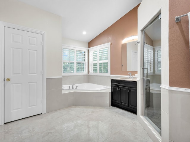 710 Crows Pt, Lake Bridgeport, TX 76426 - full bath with lofted ceiling, vanity, a garden tub, and a stall shower