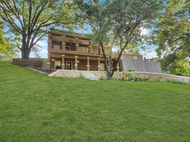 710 Crows Pt, Lake Bridgeport, TX 76426 - back of house featuring ceiling fan, a balcony, a lawn, and stucco siding