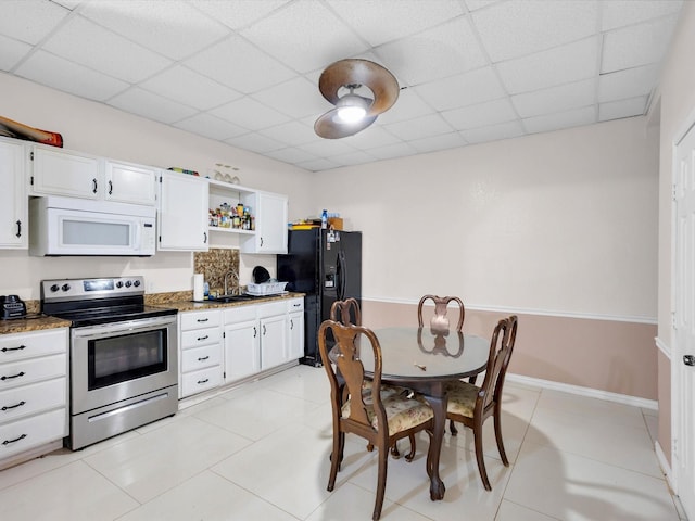 710 Crows Pt, Lake Bridgeport, TX 76426 - kitchen featuring white microwave, electric stove, black refrigerator with ice dispenser, open shelves, and a sink
