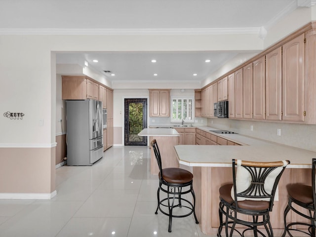 710 Crows Pt, Lake Bridgeport, TX 76426 - kitchen with black appliances, a peninsula, light countertops, a kitchen breakfast bar, and light brown cabinetry