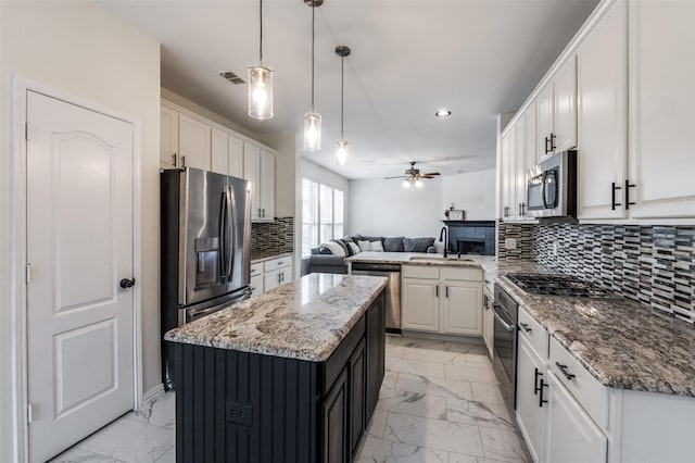 1531 Winding Trail Dr, Allen, TX 75002 - kitchen with stainless steel appliances, light marble finish flooring, open floor plan, a peninsula, and recessed lighting