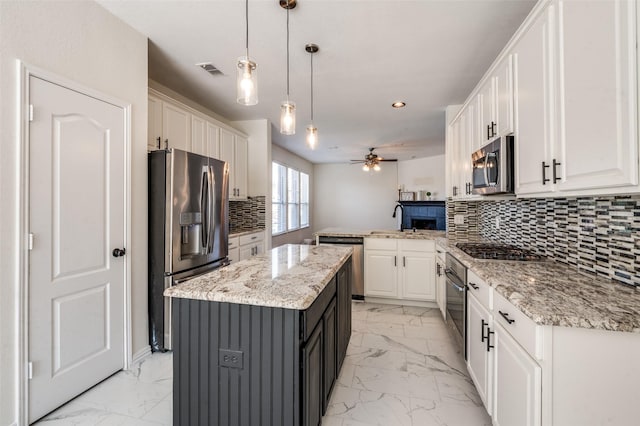 1531 Winding Trail Dr, Allen, TX 75002 - kitchen with appliances with stainless steel finishes, light marble finish floors, a sink, a peninsula, and recessed lighting
