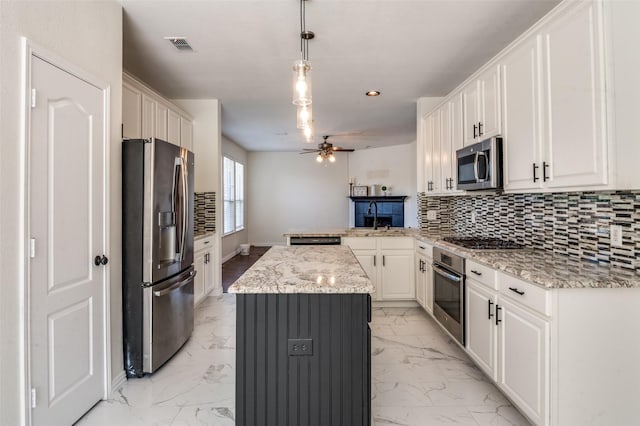 1531 Winding Trail Dr, Allen, TX 75002 - kitchen featuring appliances with stainless steel finishes, a peninsula, light marble finish floors, ceiling fan, and a sink