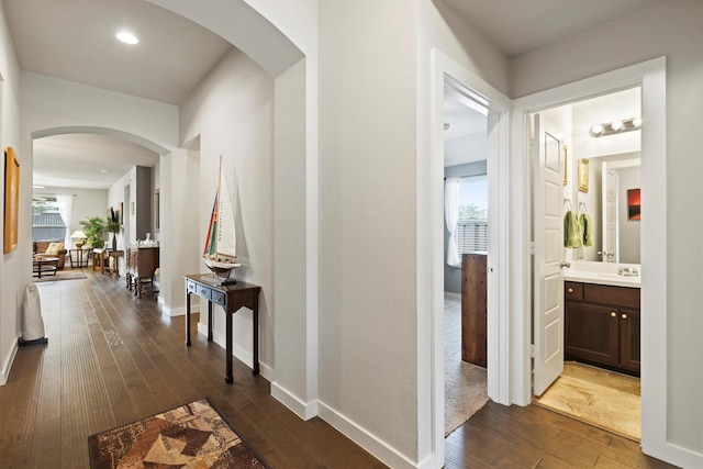 616 Forefront Ave, Celina, TX 75009 - hallway with dark wood-type flooring, arched walkways, baseboards, a sink, and recessed lighting