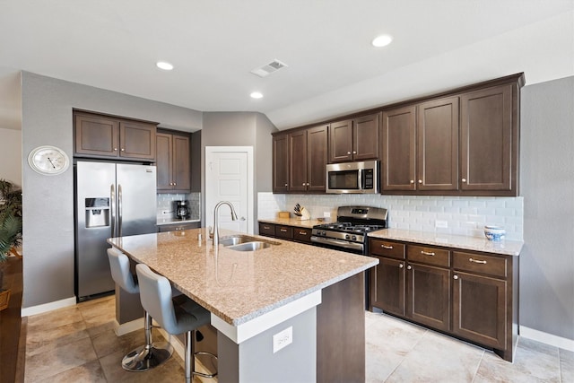 616 Forefront Ave, Celina, TX 75009 - kitchen with stainless steel appliances, a sink, dark brown cabinets, light stone counters, and recessed lighting