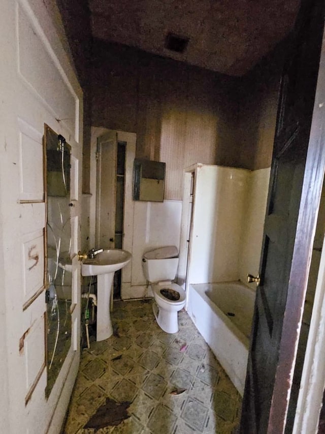 823 W Louisiana St, Palestine, TX 75801 - full bathroom with tile patterned floors, toilet, and a sink