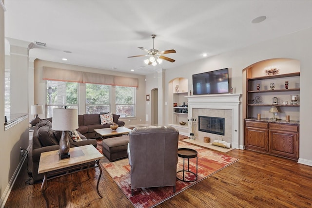 9352 Blanco Dr, Lantana, TX 76226 - living area featuring wood finished floors, a fireplace, a ceiling fan, arched walkways, and recessed lighting