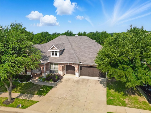 9352 Blanco Dr, Lantana, TX 76226 - view of front facade featuring a garage, driveway, brick siding, and roof with shingles
