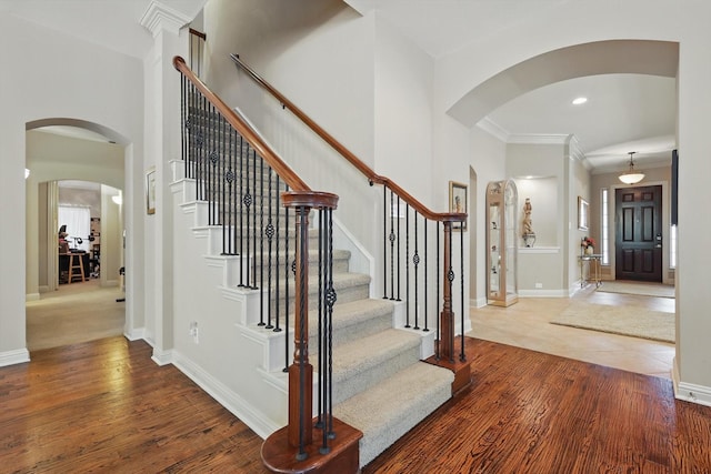 9352 Blanco Dr, Lantana, TX 76226 - foyer with arched walkways, wood finished floors, stairway, baseboards, and ornamental molding