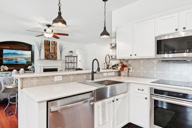 921 Stoneway Dr, Denton, TX 76210 - kitchen with stainless steel appliances, a peninsula, a sink, a ceiling fan, and open floor plan
