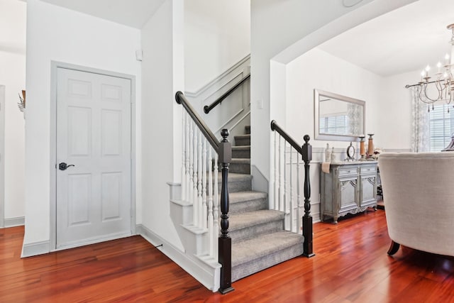 921 Stoneway Dr, Denton, TX 76210 - staircase featuring wood finished floors and a chandelier