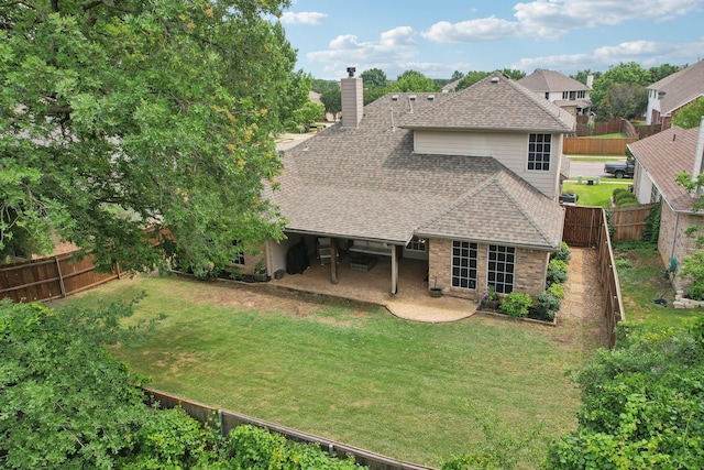 921 Stoneway Dr, Denton, TX 76210 - rear view of house featuring a shingled roof, a chimney, and a patio area