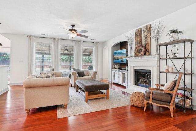 921 Stoneway Dr, Denton, TX 76210 - living area with a ceiling fan, wood finished floors, a fireplace with raised hearth, and baseboards