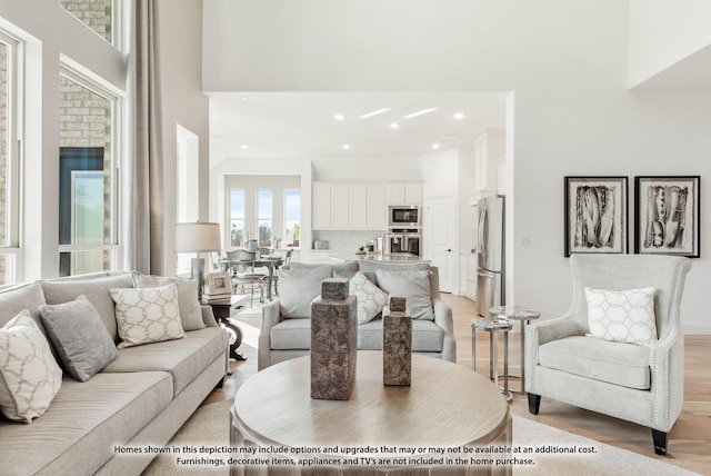 2404 Rockwood Ln, Mansfield, TX 76063 - living room with a high ceiling, light wood-style flooring, and recessed lighting