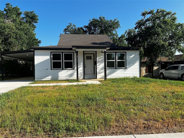 5633 Wainwright Dr, Fort Worth, TX 76112 - view of front facade featuring a front yard, an attached carport, and concrete driveway