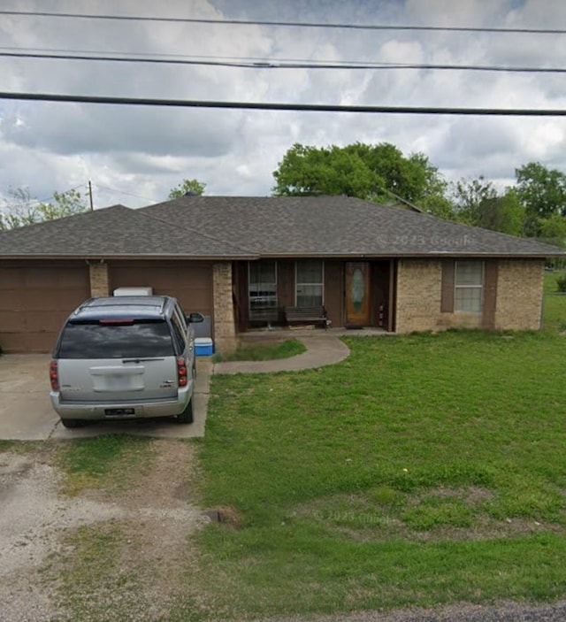 104 W Maple, Gunter, TX 75058 - ranch-style house featuring driveway, an attached garage, a front yard, and brick siding