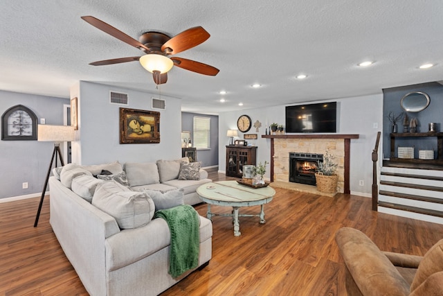 6171 Inca Dr, Mabank, TX 75156 - living room with a fireplace, baseboards, a ceiling fan, wood finished floors, and a textured ceiling
