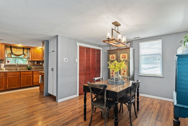 6171 Inca Dr, Mabank, TX 75156 - dining space with light wood-style floors, healthy amount of natural light, baseboards, and a textured ceiling