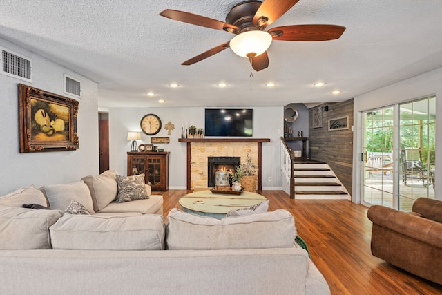 6171 Inca Dr, Mabank, TX 75156 - living area with wood finished floors, a fireplace, a textured ceiling, recessed lighting, and a ceiling fan