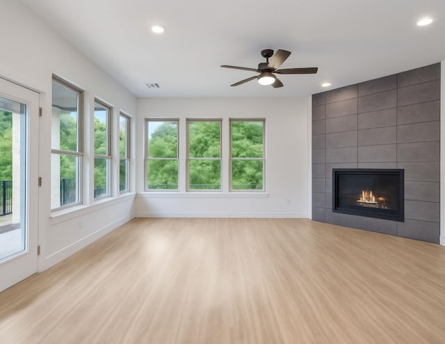 821 Hearthside Way, Mckinney, TX 75071 - unfurnished living room with recessed lighting, a tile fireplace, baseboards, a ceiling fan, and light wood-style floors