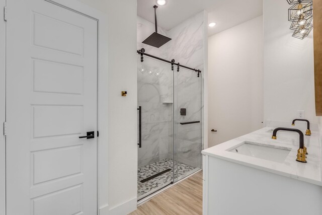 821 Hearthside Way, Mckinney, TX 75071 - full bath with a marble finish shower, wood finished floors, and double vanity