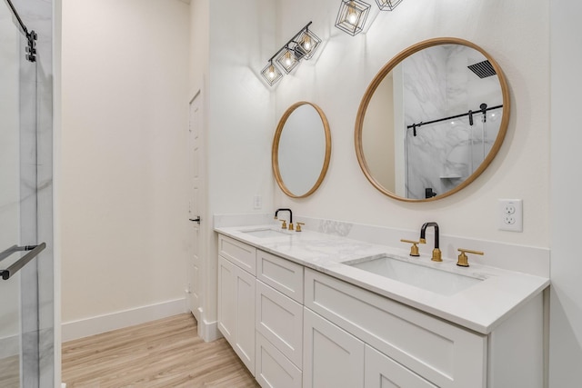 821 Hearthside Way, Mckinney, TX 75071 - bathroom featuring double vanity, wood finished floors, a shower, and baseboards