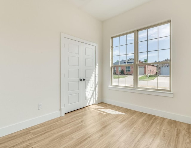 821 Hearthside Way, Mckinney, TX 75071 - empty room with baseboards and light wood-type flooring