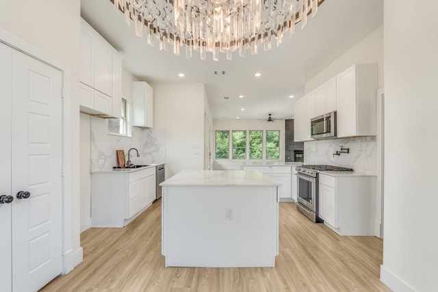 821 Hearthside Way, Mckinney, TX 75071 - kitchen featuring appliances with stainless steel finishes, a sink, decorative backsplash, light countertops, and recessed lighting