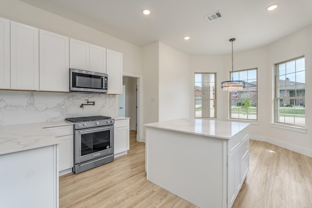 821 Hearthside Way, Mckinney, TX 75071 - kitchen featuring stainless steel appliances, light wood-type flooring, a chandelier, healthy amount of natural light, and recessed lighting